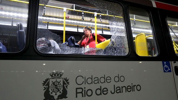 A member of the media stands near a shattered window on a bus in the Deodoro area of Rio de Janeiro Brazil at the 2016 Summer Olympics