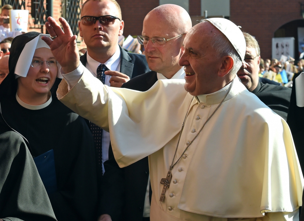 Pope Francis greets faithful as he arrives at the Shrine of Divine Mercy in Krakow Poland Saturday