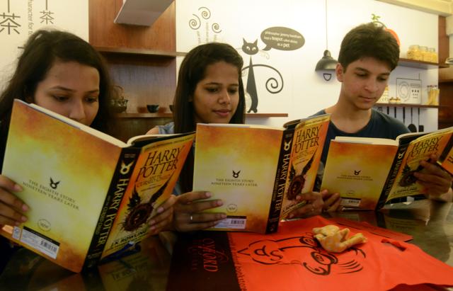 Potter fans read the Harry Potter and the Cursed Child at a bookstore in Kolkata