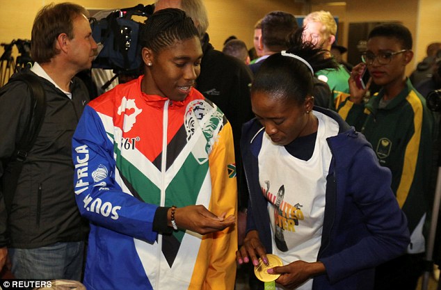 Home South Africa's Rio 2016 Olympic Games gold medalist Caster Semenya passes her medal to her wife Violet Raseboya after arriving at Johannesburg Airport this morning