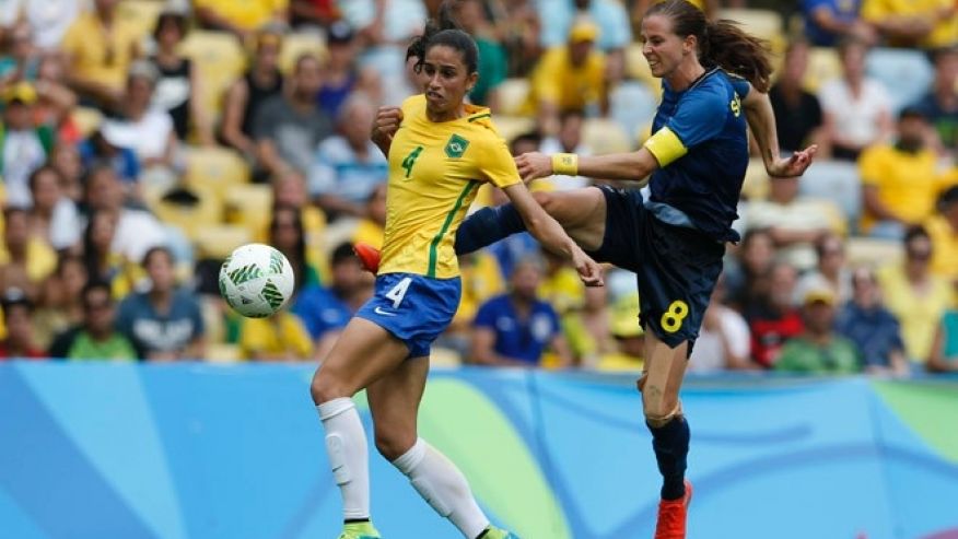 Sweden's Lotta Schelin right kicks the ball challenged by Brazil's Rafaelle during a extra time of a semi-final match of the women's Olympic football tournament between Brazil and Sweden at the Maracana stadium in Rio de Janeiro Brazil