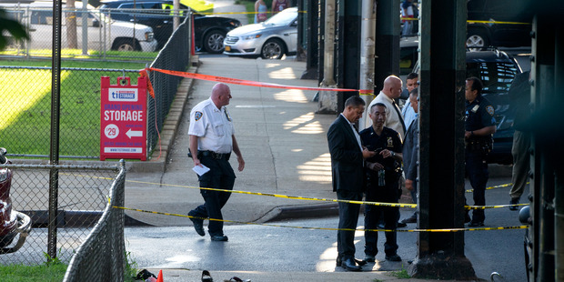 Sandals mark the crime scene not far from the Al Furqan Jame Masjid Mosque in the Ozone Park neighbourhood of Queens New York