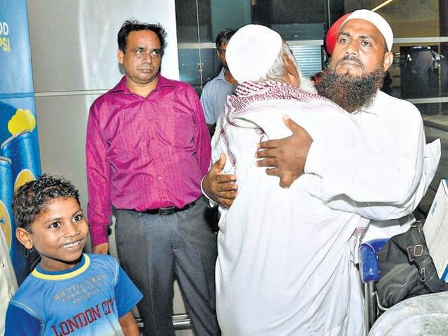 Musharraf Ali from U.P. hugs his father after arriving from Jeddah at the IGI airport in New Delhi on Thursday. Ali’s son is all smiles