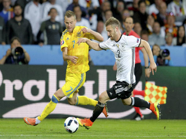 Shkodran Mustafi fights for the ball with Ukraine's Andriy Yarmolenko during the Euro 2016 Group C match