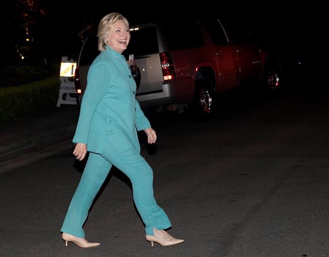 Democratic presidential nominee Hillary Clinton walks to greet people on the street as she leaves a fundraiser in Piedmont Calif. Tuesday Aug. 23 2016