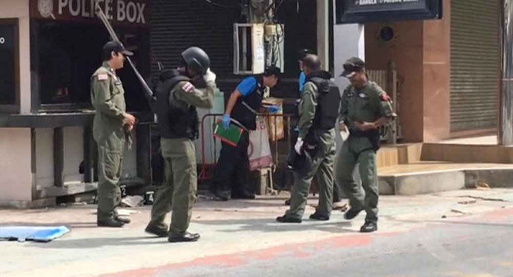 Officials investigate at the scene of bomb blasts in the tourist beach town of Patong on Phuket island Thailand in this still image from video