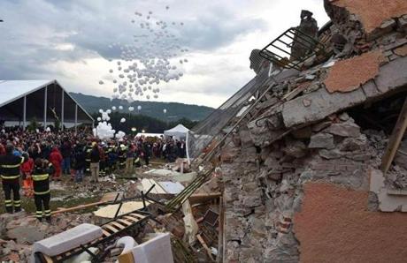 White balloons are released during a funeral service for victims of the earthquake that levelled the town in Amatrice central Italy