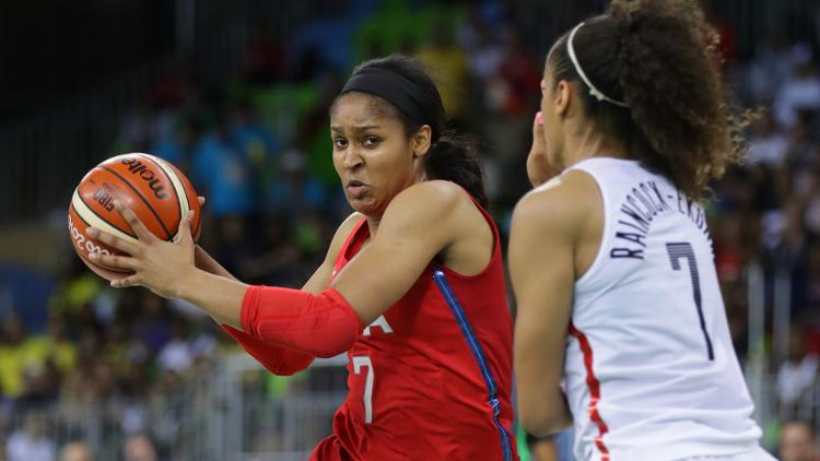 United States forward Maya Moore dribbles the ball as Canada forward Nayo Raincock Ekunwe defends during the women's team preliminary in the Rio 2016 Summer Olympic Games at Youth Arena