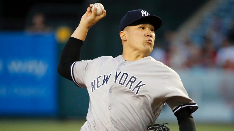 Tanaka throws a pitch in the first inning