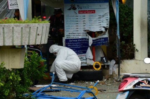 Thai forensic specialists collect evidence from the crime scene after a bomb exploded in the tourist town of Hua Hin