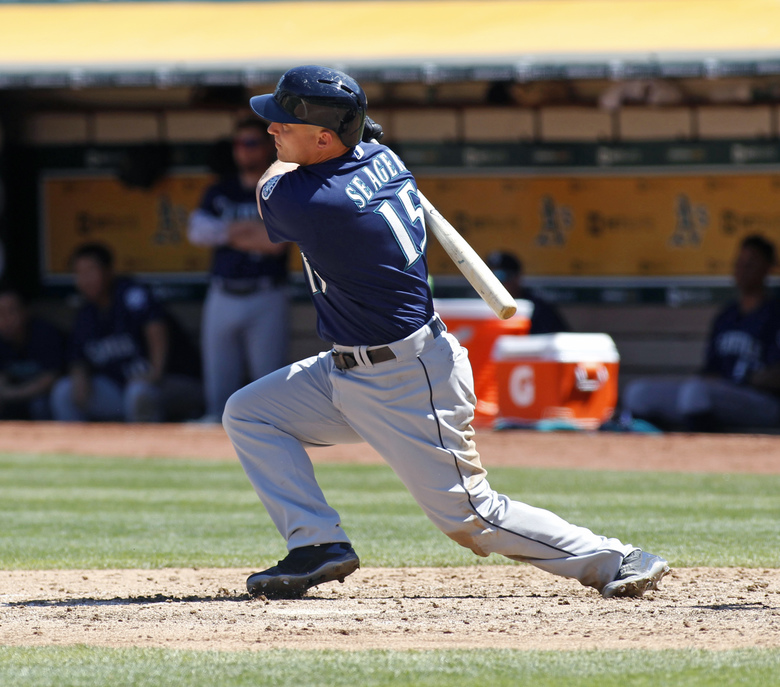 The Mariners’ Kyle Seager hits a three-run double against the Oakland Athletics during the sixth inning