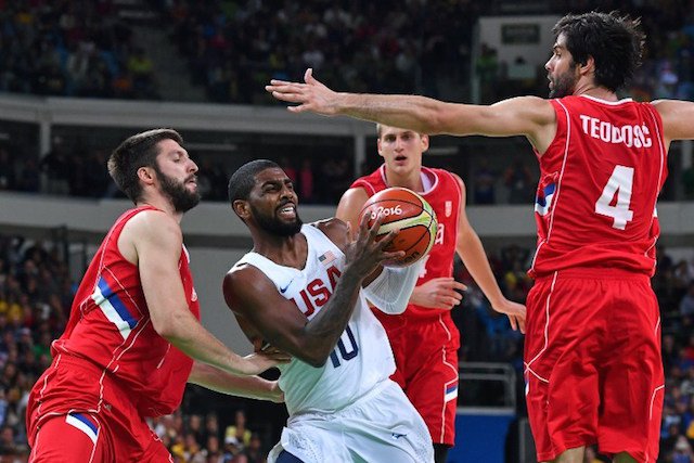 USA's guard Kyrie Irving is cornered by Serbia's point guard Stefan Markovic Serbia's power forward Nikola Jokic and Serbia's guard Milos Teodosic during a Men's round Group A basketball match between USA and Serbia at the Carioca Arena 1