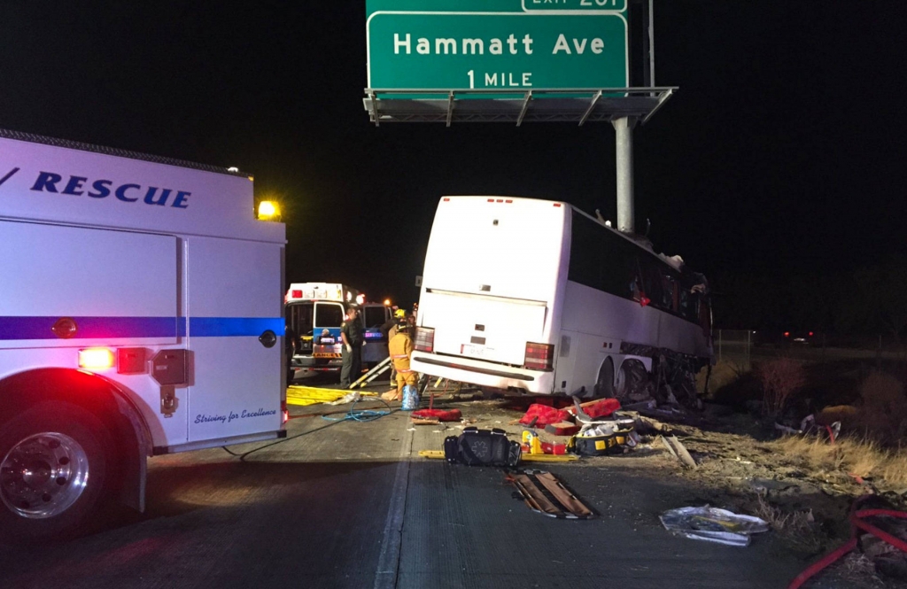 The charter bus struck a highway sign which sheared it nearly in half