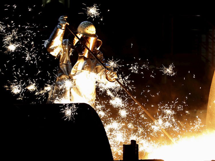 A worker controls a tapping of a blast furnace at Europe's largest steel factory of Germany's industrial conglomerate Thyssen Krupp AG in the western German city of Duisburg