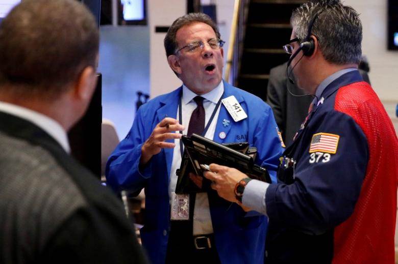 Traders work on the floor of the New York Stock Exchange shortly after the opening bell in New York