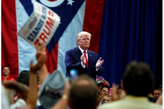 Republican presidential candidate Donald Trump applauds after speaking during a town hall event Monday Aug. 1 2016 in Columbus Ohio