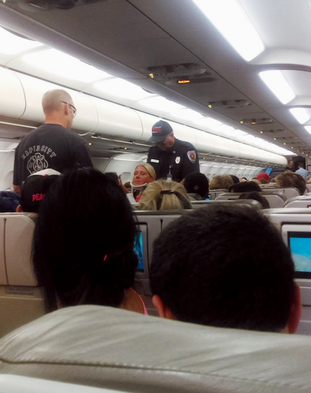 Lynam shows a crew member in a neck brace being removed from a Jet Blue aircraft after it landed at the airport in Rapid City S.D. Jet Blue says passengers and crew members were injured when turbulence