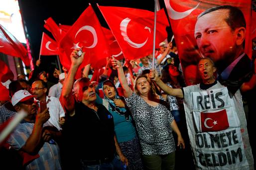 FLAG WAVING Turks gathered in solidarity to oppose the July 15 coup attempt. The banner on the right reads 'Chief Erdogan I came to die.&#039