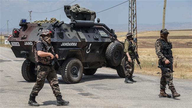 Turkish soldiers are seen at a military checkpoint outside the Lice district in Diyarbakir Province southeastern Turkey