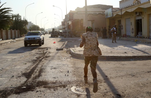 A member of the forces loyal to Libya's UN-backed Government of National Accord runs on a street