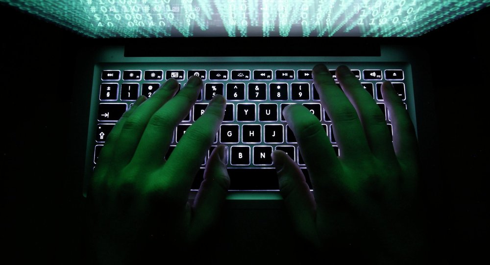 A man types on a computer keyboard