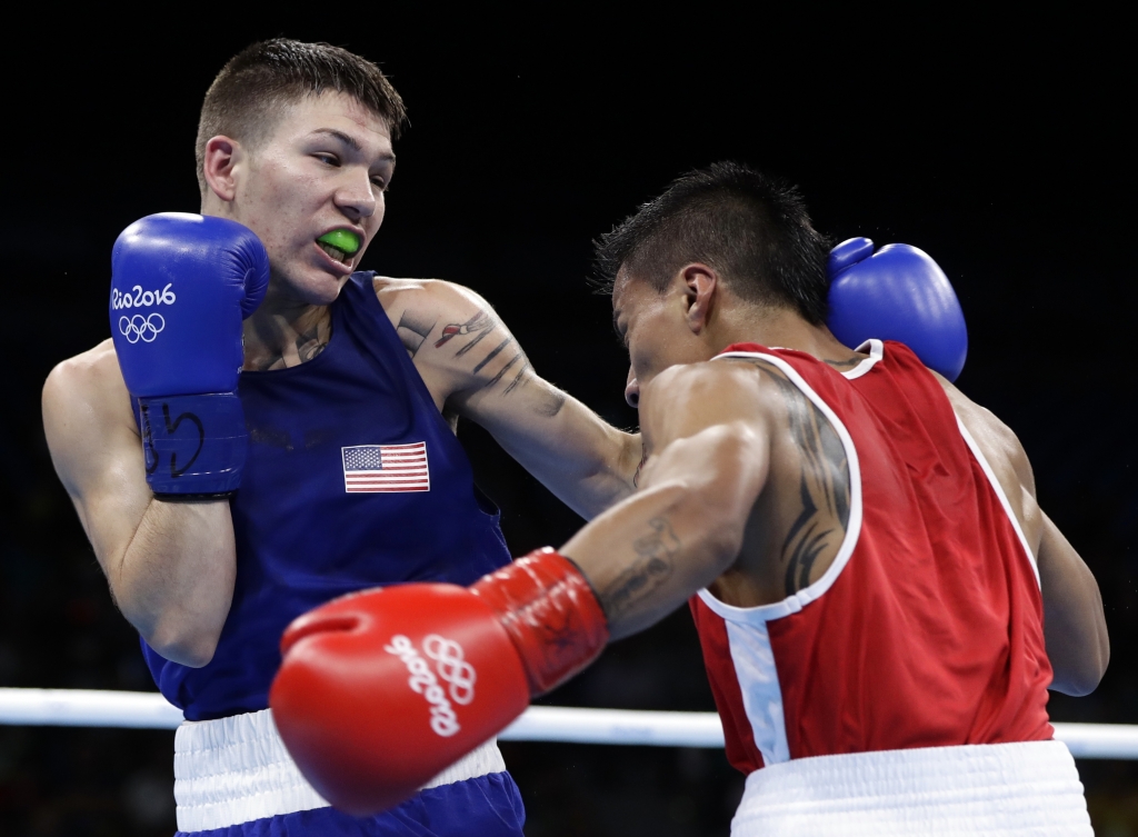 United State's Nico Miguel Hernandez left fights Ecuador's Carlos Eduardo Quipo Pilataxi during a men's light flyweight 49-kg quarterfinals boxing match at the 2016 Summer Olympics in Rio de Janeiro Brazil Wednesday Aug. 10 2016. (AP