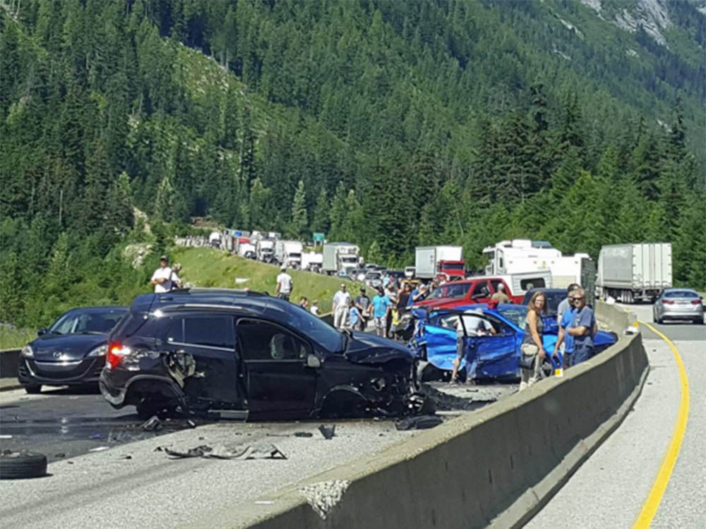 Wrecked vehicles block the Coquihalla Highway's southbound lanes east of Hope after a Friday afternoon crash