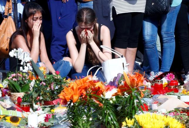 Young women mourning outside the Olympia shopping mall in Munich Germany