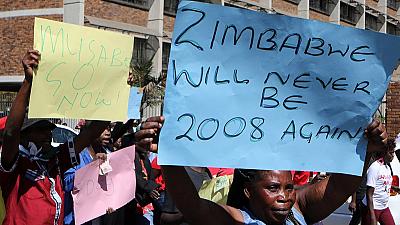 Zimbabwe police break up Harare protests with tear gas & water canon