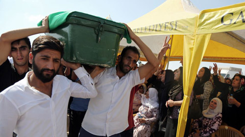 People carry a victims coffin as they attend funeral services for dozens of people killed in last nights bomb attack targeting an outdoor wedding party in Gaziantep southeastern Turkey on Aug. 21 2016. /AP