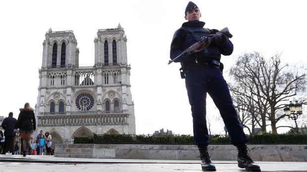 A French police officer stands guard outside Notre Dame cathedral in Paris earlier this year