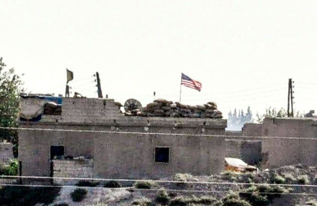 A US flag is flown at the People's Protection Units position in the Syrian city of Tal-Abyad