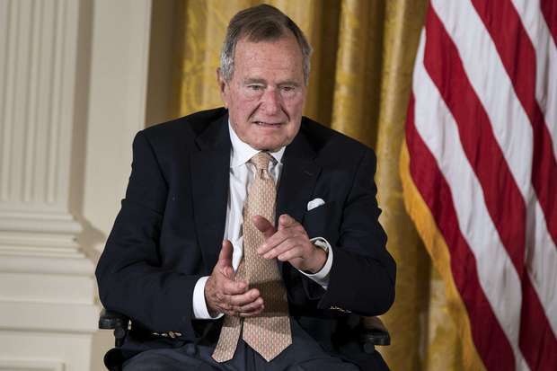 A report says former President George H.W. Bush plans to vote for Hillary Clinton. File