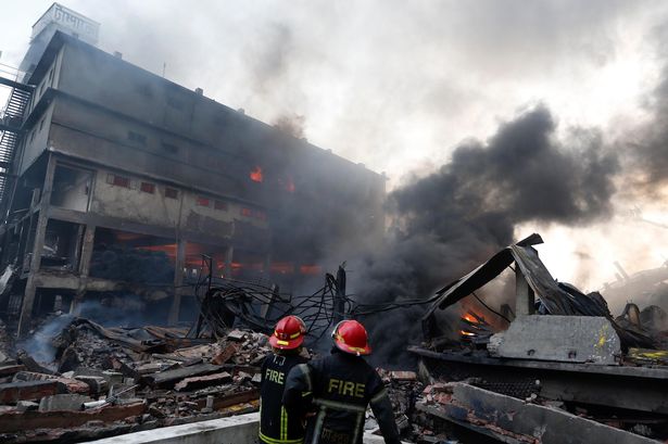 Firefighters work to put out a fire at a packaging factory in Tongi industrial area outside Dhaka Bangladesh