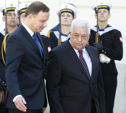 Polish President Andrzej Duda left and Palestinian President Mahmoud Abbas inspect the honor guard during an official welcoming ceremony in the courtyard of the presidential palace in Warsaw Poland Tuesday Sept. 6 20