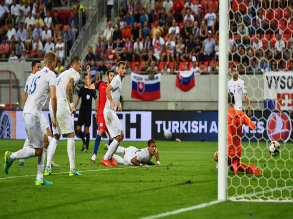 Adam Lallana scores past Slovakian defenders