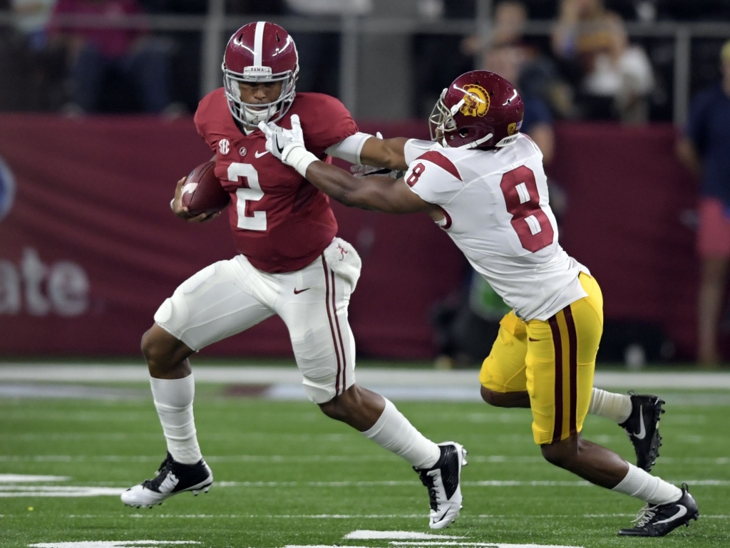 Alabama quarterback Jalen Hurts stiff-arms USC cornerback Iman Marshall in the Tide's victory Saturday