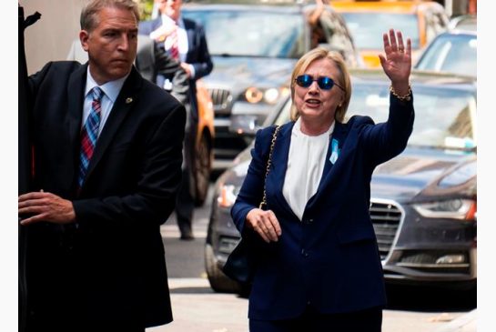 Democratic presidential candidate Hillary Clinton walks from her daughter's apartment building Sunday Sept. 11 2016 in New York. Clinton unexpectedly left Sunday's 9/11 anniversary ceremony in New York after feeling