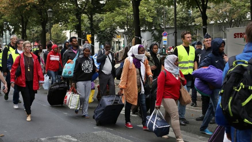 Migrants are evacuated from a camp in the north of Paris Friday Sept. 16 2016. Police and city officials are evacuating hundreds of migrants who had been living on the streets of northern Paris for weeks in the latest of a string of attempts to find