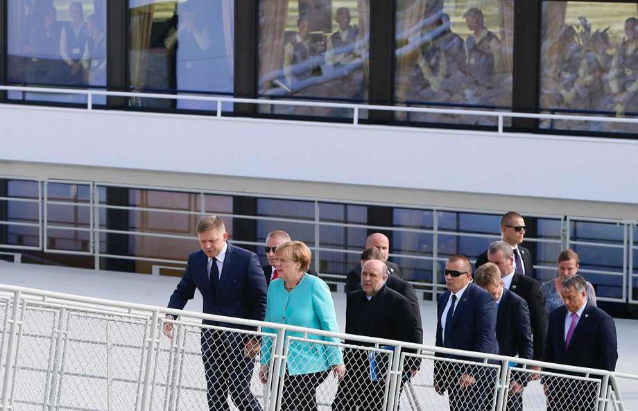 Slovakian Prime Minister Robert Fico left German Chancellor Angela Merkel and Hungarian Prime Minister Viktor Orban right alight after taking a boat down the Danube river during an EU summit in Bratislava Slovakia Friday Sept. 16 2016. An EU summi