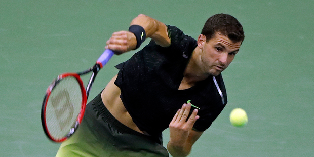 Bulgarian Grigor Dimitrov serves to Andy Murray at the U.S. Open tennis tournament