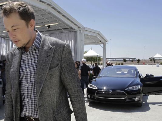 CEO Elon Musk walks past the Tesla Model S at the factory in Fremont Calif