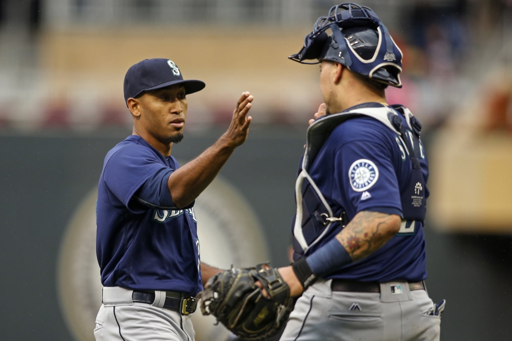 Seattle Mariners relief pitcher Edwin Diaz left celebrates with catcher Jesus Sucre after defeating the Minnesota Twins in a baseball game Sunday Sept. 25 2016 in Minneapolis