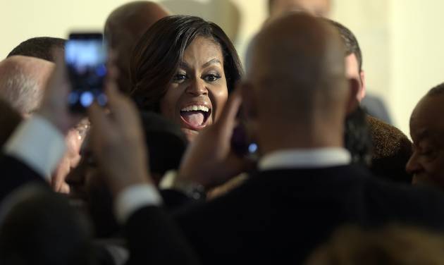 First lady Michelle Obama greets people in the crowd after President Barack Obama spoke in the Grand Foyer of the White House in Washington Friday Sept. 23 2016 at a reception for the Smithsonian Museum of African American History and Culture. (AP Pho