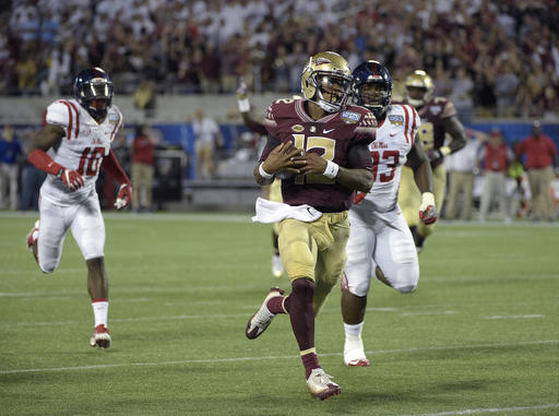 Florida State quarterback Deondre Francois runs past Mississippi defensive end Marquis Haynes and defensive tackle D.J. Jones for a long gain during an NCAA