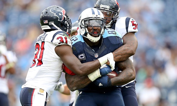 NASHVILLE TN- DECEMBER 27 Charles James #31 and Akeem Dent #50 of the Houston Texans wrap up Delanie Walker #82 of the Tennessee Titans at LP Field