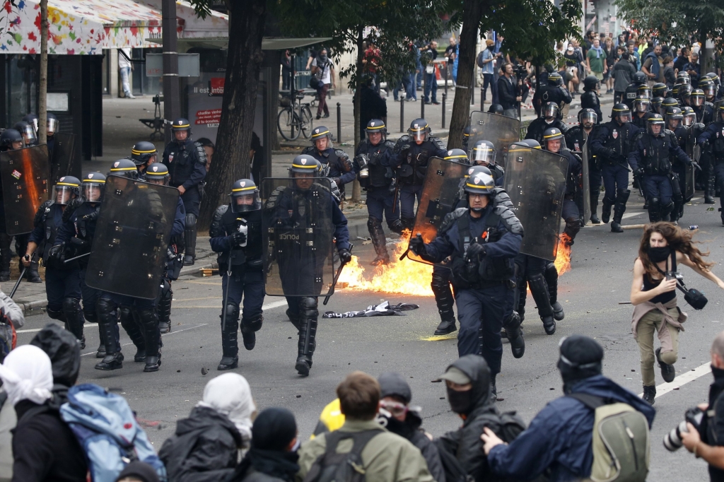 Demonstrators clash with French riot police during a march in Paris France to demonstrate against the new French labour law