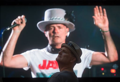 Lead singer Gord Downie is seen performing on a screen as a man watches during a viewing party for the final stop in Kingston Ontario from Vancouver British Columbia Saturday Aug. 20 2016. The Tragically Hip mixed fan favourites newer songs and some