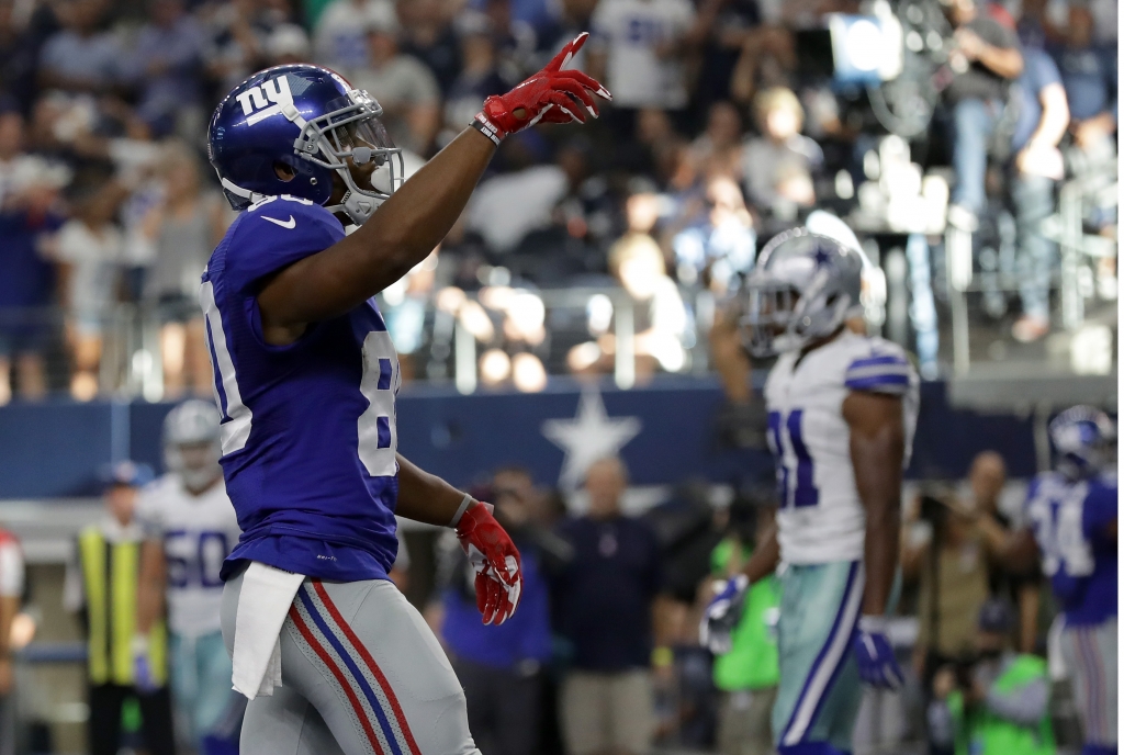 ARLINGTON TX- SEPTEMBER 11 Victor Cruz #80 of the New York Giants celebrates after catching a touchdown pass during the fourth quarter against the Dallas Cowboys at AT&T Stadium