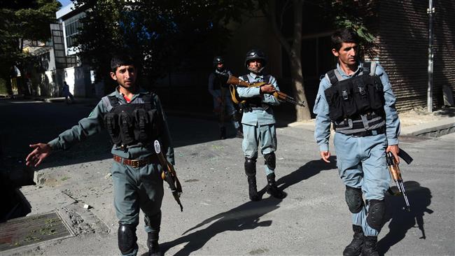 Afghan security personnel patrol near the site of an ongoing attack on a charity in central at the Shar-e Naw in Kabul